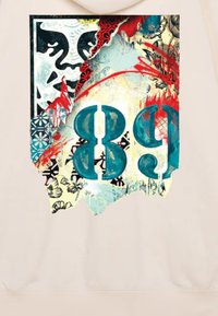 Helle beige Kapuzenjacke mit einem grafischen Design, das die kräftige türkisfarbene "89", florale Muster, rote Spritzer und abstrakte Texturen im Hintergrund zeigt.