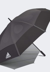 Black umbrella with a smooth, matte texture, featuring a metallic silver underside and an Adidas logo on the canopy.