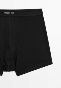 Black boxer briefs made of stretchy cotton, featuring a soft waistband with "Massimo Dutti" logo, smooth texture, and a classic fit design.