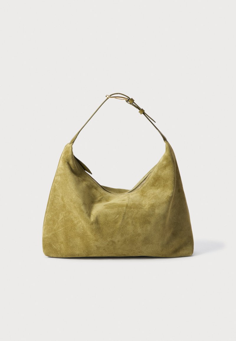 Green suede handbag with a hobo shape, featuring a single strap and a smooth texture. Notable for its minimalist design and curved silhouette.