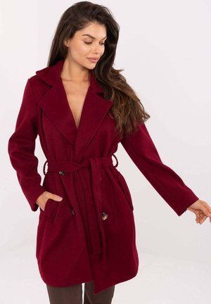 Burgundy wool overcoat with a belted waist, notched lapels, two front pockets, and two large buttons for closure. Smooth texture.