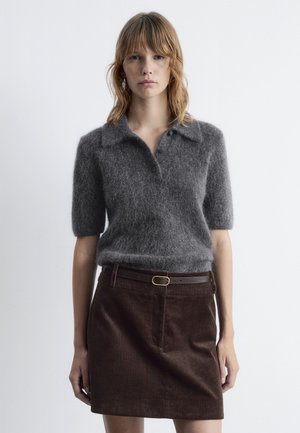 Gray, short-sleeved knit polo sweater with a soft texture and a collar, paired with a brown corduroy mini skirt and a matching belt.