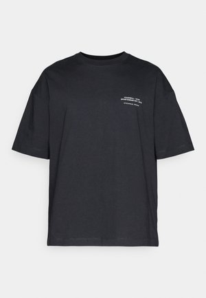 Czarna bawełniana koszulka z krótkim rękawem, okrągłym dekoltem i białym napisem po lewej stronie. Luźny krój, gładka struktura, bez wzorów.