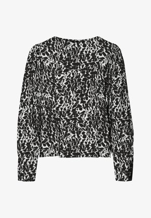 Langärmelige schwarz-weiße Bluse mit abstraktem Tiermuster und leicht gepolsterten Schultern.