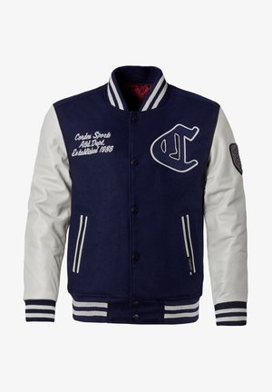 Navy blue varsity jacket with white leather sleeves, embroidered logo, and text. Features striped ribbed collar and cuffs, snap closure, and pockets.