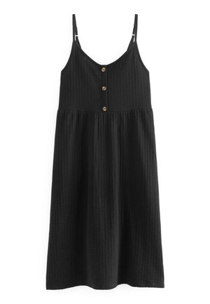 Robe midi noire sans manches avec fines bretelles réglables, tissu texturé et trois boutons marron sur le devant du corsage.