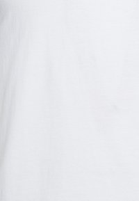White cotton fabric with a smooth texture, displaying a uniform surface and no visible patterns or embellishments.