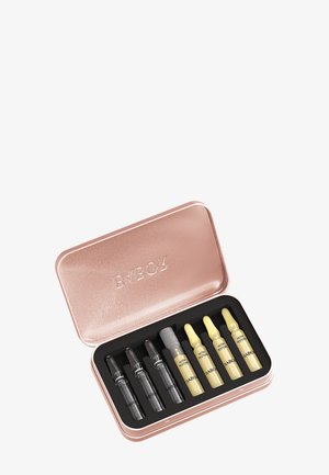 Prostokątne różowe metalowe pudełko z wytłaczanym wieczkiem, zawierające sześć szklanych ampułek — trzy przezroczyste i trzy żółte — oznakowane BABOR, umieszczone w czarnej piankowej wkładce.