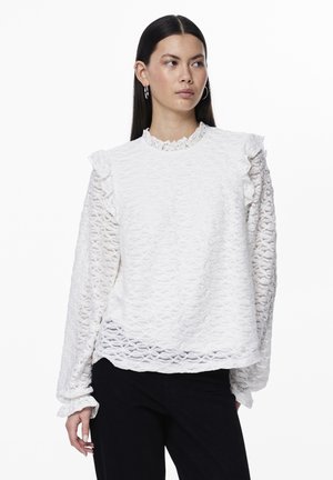 White textured blouse with ruffled shoulders and long sleeves, featuring a floral pattern and a round neckline. Soft, lightweight fabric.