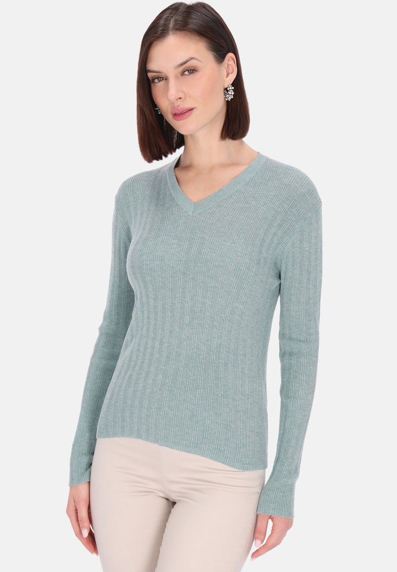 Maglione a scollo a V in tessuto a coste color verde acqua chiaro, con maniche lunghe e silhouette aderente. Texture notevole e design pulito.