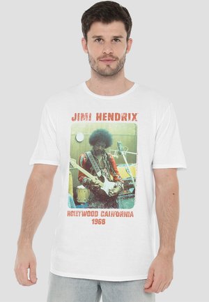 White cotton t-shirt featuring a vintage Jimi Hendrix graphic with red and green accents, rectangular frame, and text stating "HOLLYWOOD CALIFORNIA 1968."