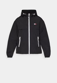 Zwarte capuchonjas met witte rits en ritsen op de zakken, elastische manchet en een klein rood, wit en blauw logo op de linkerkant van de borst.
