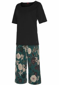 Black short-sleeve top with a square neckline paired with teal floral print wide-leg pants featuring large off-white and purple flowers.