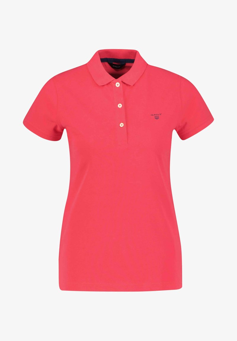 Polo rouge à manches courtes avec trois boutons blancs et un petit logo sur le côté gauche de la poitrine.