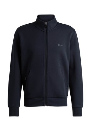 Navy zip-up jacket made of smooth, lightweight fabric. High collar, side pockets, and a small tonal logo on the chest. Fitted cuffs.