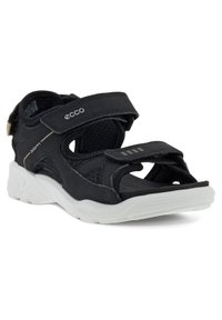 Svarta Ecco-sandaler med justerbara Velcro-remmar, texturerad syntetisk överdel och en vit gummisula med konturerad form och dämpning.