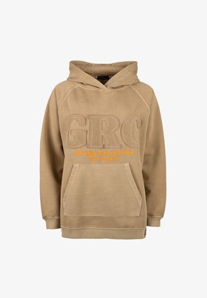 Beige hooded sweatshirt with kangaroo pocket, raised textured "GRC" letters, and orange text "STUDIO COLLECTION EST. IN 2013" on front.