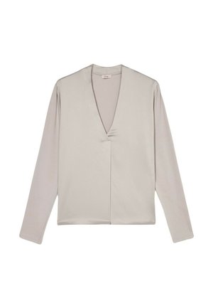 Maglietta a maniche lunghe di un leggero beige con scollatura a V, realizzata in tessuto morbido. Presenta un design con piega frontale e semplici dettagli di cucitura.