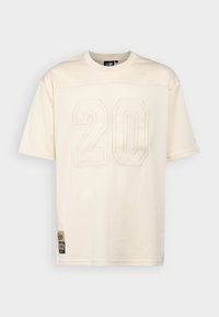New Era Marškinėliai su spaudiniu - beige
