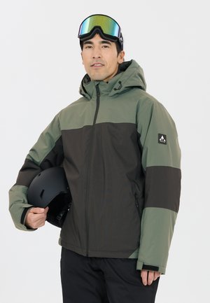 Green and black insulated jacket with a hood, zippered pockets, and branded logo. Worn with a black helmet and mirrored goggles.