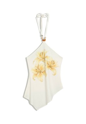 Top blanc à col halter avec un ourlet asymétrique et un imprimé floral de lys jaune au centre devant, orné de perles sur les bretelles.