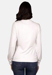Weißer Sweatshirt mit langen Ärmeln, Rundhalsausschnitt und gerippten Bündchen, mit glatter Textur und taillierter Silhouette. Texturierte Rückansicht.
