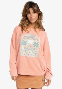 Helles rosa Oversized-Sweatshirt aus strukturiertem Stoff, mit einem bunten Grafikdesign mit Palmen und Blumen in der Mitte.