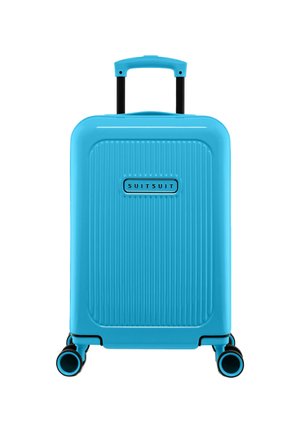 Turquoise hard-shell suitcase with vertical ribbed design, extending handle, and four black wheels for mobility. Suitsuit brand logo visible.