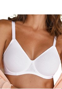 Balts bezvadu krūšturis ar teksturētu viļņu rakstu, gludu apdari un regulējamām siksnām. Ir klasiskas trīsstūra kausu dizains.