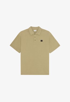 Khaki polo tričko s krátkymi rukávmi, trojica gombíkov na zapínanie a malá vyšitá značka na ľavej hrudi. Hladká bavlnená tkanina.