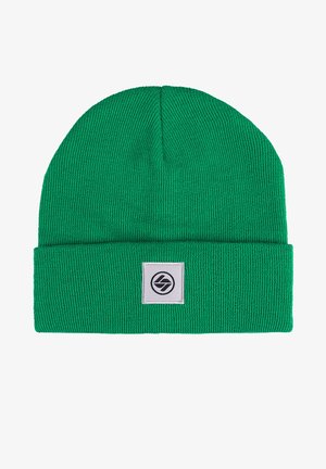 Green knitted beanie with a cuff, featuring a square patch with a black logo. Material is soft and textured, designed for warmth.