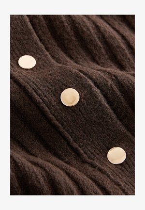 Brown textured fabric featuring vertical ribbing and three prominent gold-tone buttons. The material appears soft and warm.
