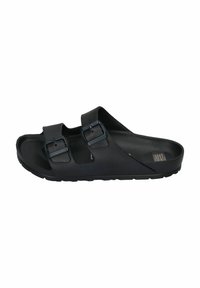 Black sandals made of flexible material, featuring two adjustable buckles, a contoured footbed, and a textured outsole for grip.