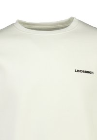 Sudadera de color crema claro hecha de un tejido suave. Cuenta con un cuello redondo y texto bordado en negro "LINDBERG" en la parte izquierda del pecho.