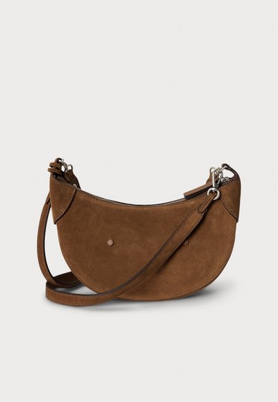 Brown suede handbag with a curved shape, featuring a zipper closure, adjustable strap, and simple metallic hardware accents.
