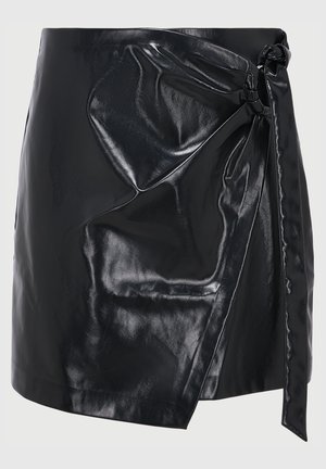 Schwarzer Lederwickelrock mit glänzender Oberfläche, der eine Frontbindung und eine drapierte Textur aufweist. Kurze Länge und minimalistisches Design.