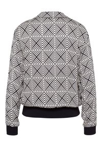 Gemusterte Bomberjacke mit einem schwarz-weißen Polka-Dot-Design, gerippten Bündchen und einem einfarbigen schwarzen Saum, gefertigt aus einem glatten Stoff.