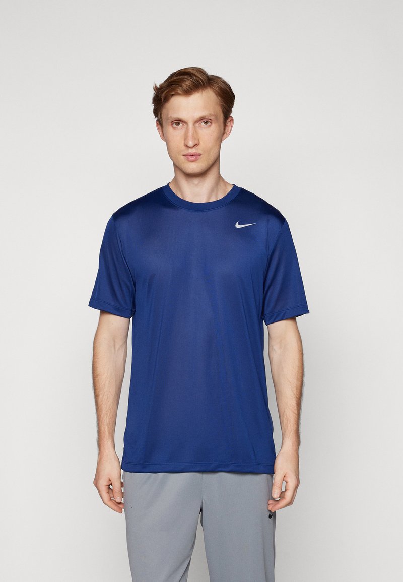 T-shirt de sport Nike bleu à manches courtes, col rond, en tissu léger, arborant un petit logo blanc sur l'épaule gauche.