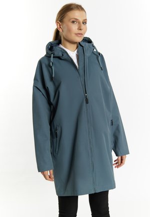 Lichte teal regenjas met een capuchon, voorzak met rits en zijzakken. Voorzien van trekkoorden en een relaxte pasvorm voor comfort.