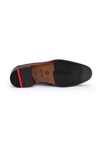 Brown leather shoe sole with a black rubber heel. Textured grip pattern and red accent on the heel. Logo imprint on the leather.