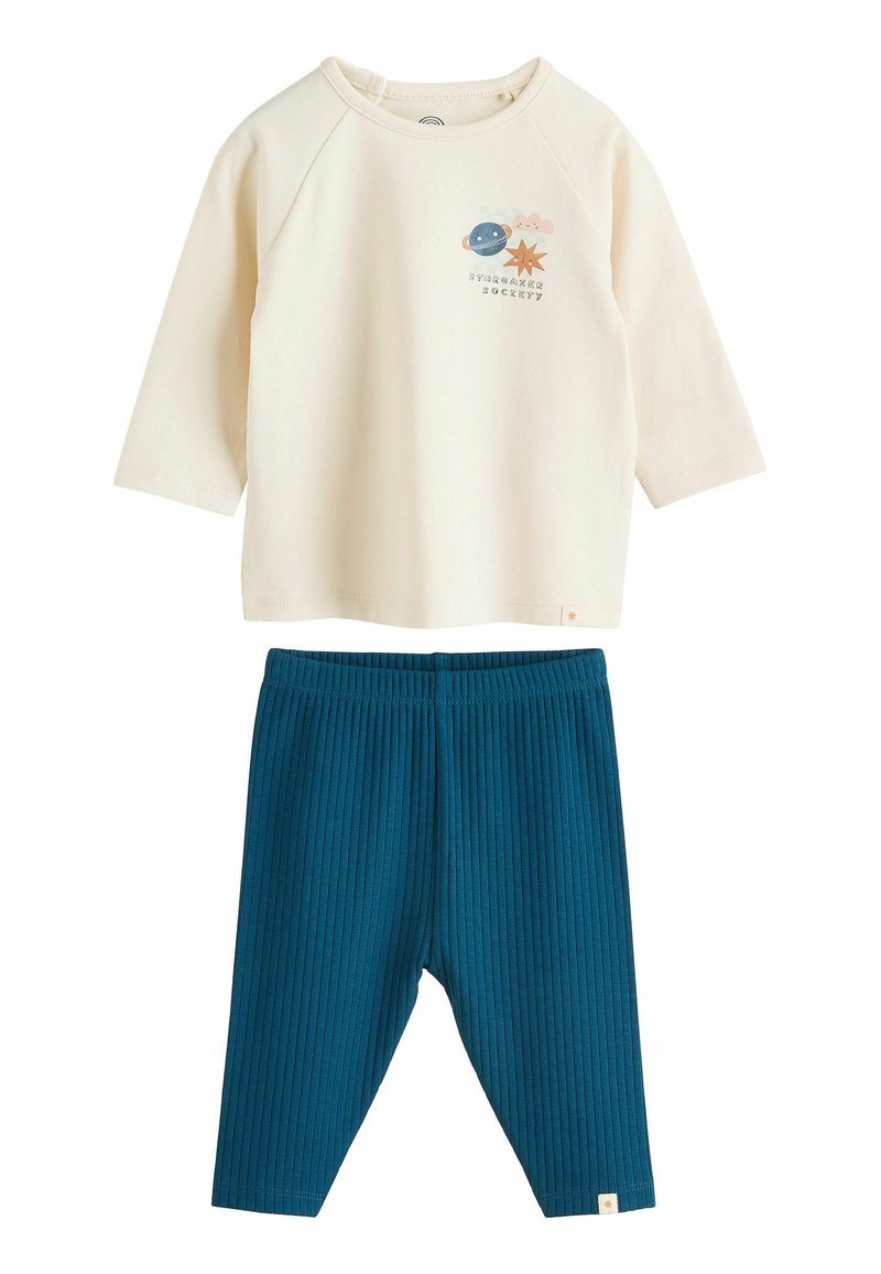 Maglietta a maniche lunghe color crema con design a tema spaziale; leggings teal a coste con elastico in vita. Tessuto in cotone morbido in tutto.