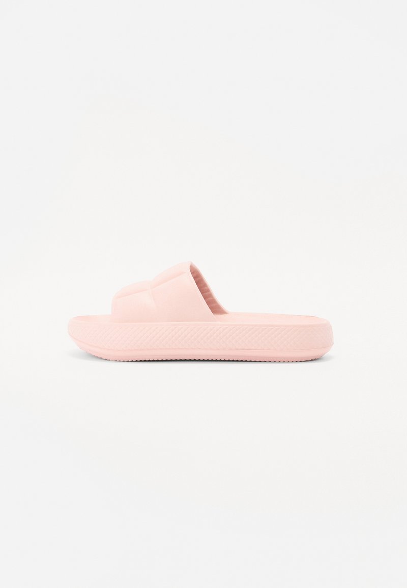 Pink rubber slide sandal featuring a textured sole and a wide band across the top. Flat design with a minimalistic shape.