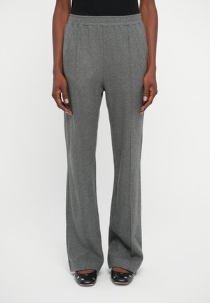 Gray, textured, wide-leg pants with an elastic waistband. Front pleats enhance the design. Paired with dark, rounded toe shoes.