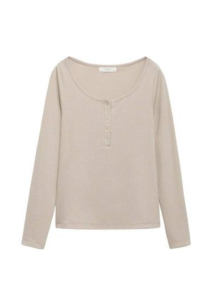 Långärmad topp i ljus beige ribbad tyg, med rundad halsringning och en knappslå med fyra knappar i mitten.