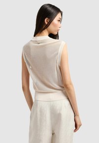 Top senza maniche leggero beige in tessuto a rete con orlo a coste, caratterizzato da una vestibilità rilassata e una texture sottile. Vista posteriore mostrata.