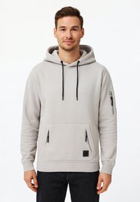 Light gray hoodie made of soft fabric, featuring a large front pocket, side zip pocket, adjustable drawstrings, and logo patch.