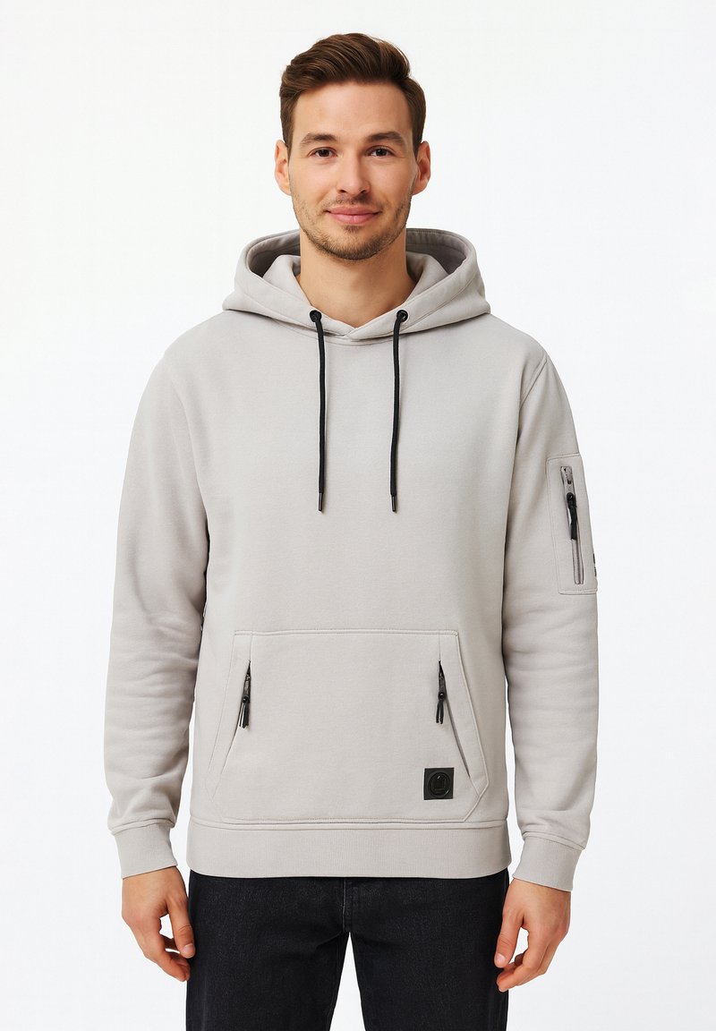 Light gray hoodie made of soft fabric, featuring a large front pocket, side zip pocket, adjustable drawstrings, and logo patch.