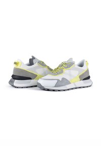 Running shoes featuring a grey mesh upper, white and grey suede accents, neon yellow details, and black rubber sole.
