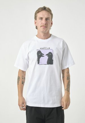 White cotton t-shirt featuring a black graphic of two bird heads against a light purple background. Short sleeves, relaxed fit, crew neck.
