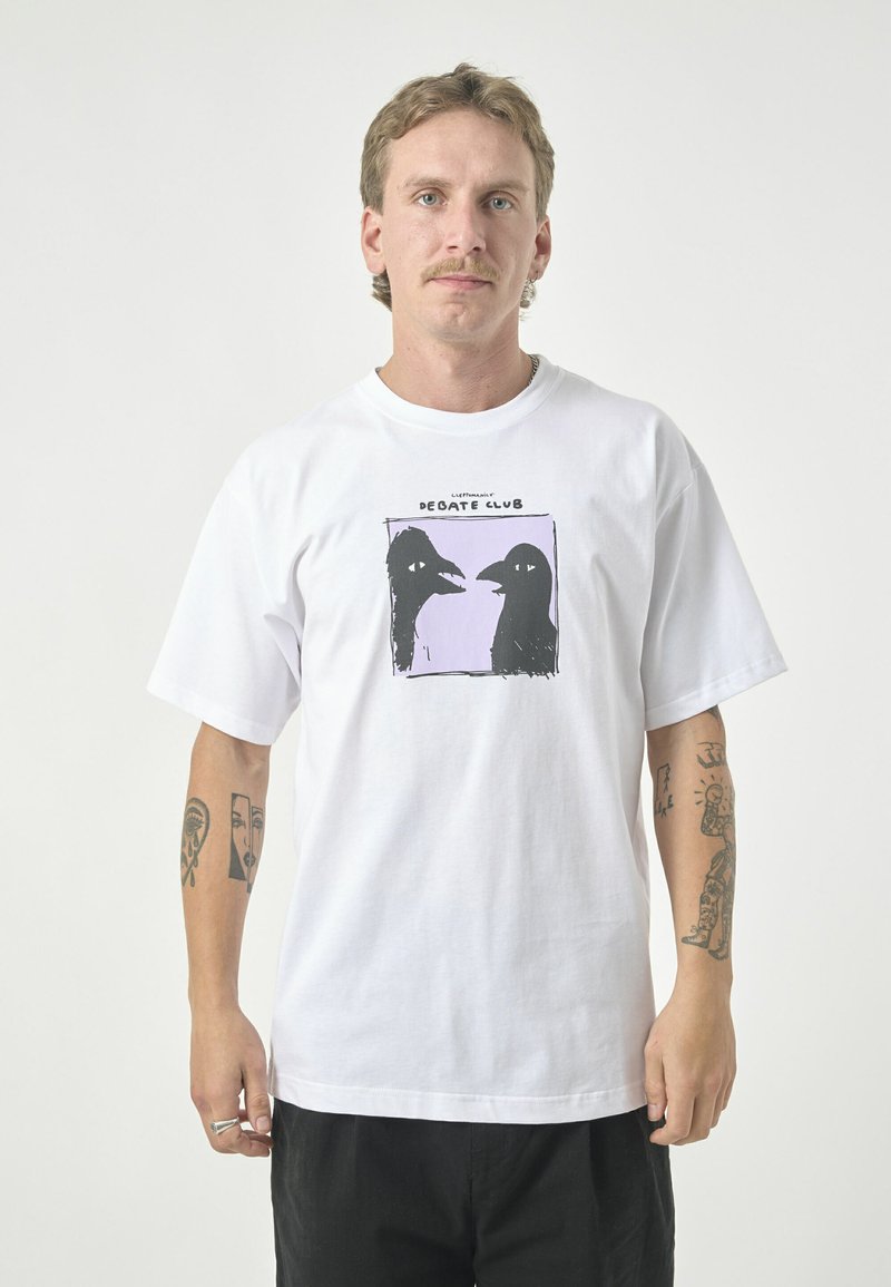 White cotton t-shirt featuring a black graphic of two bird heads against a light purple background. Short sleeves, relaxed fit, crew neck.